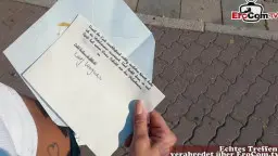 Hand mit Brief auf Kopfsteinpflaster, Liebesbrief und Kondom auf dem Boden